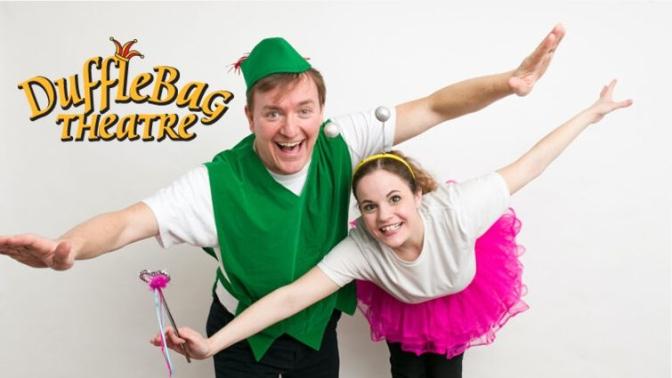 two actors in costume as peter pan and tinkerbell wtih arms outstretched pretending to fly