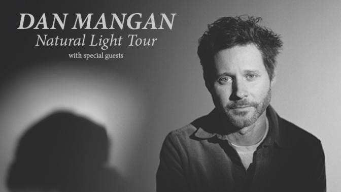 Black and white portrait of musician Dan Mangan with large shadow in background