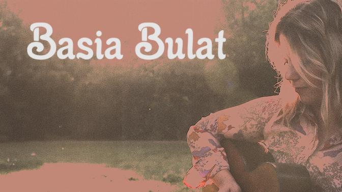 artistic rose colored portrait of musician basia bulat playing her guitar