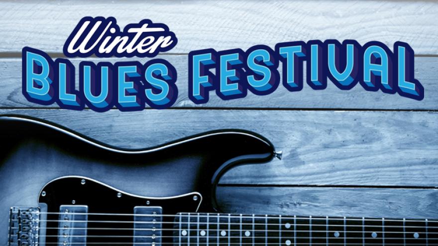 electric guitar on a wooden floor in shades of blue