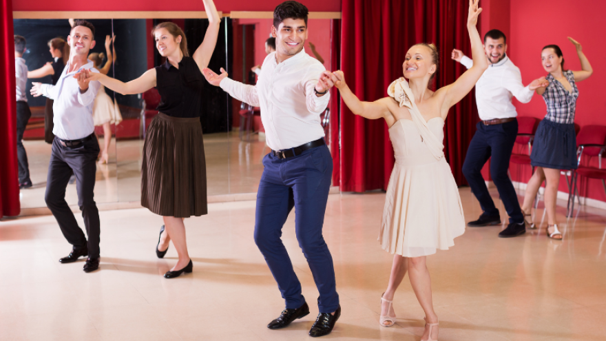 Couples practicing dance moves together