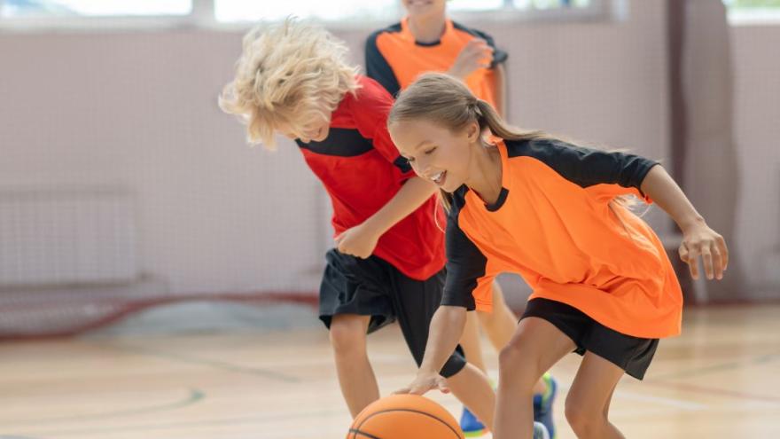 Three kids running in gym