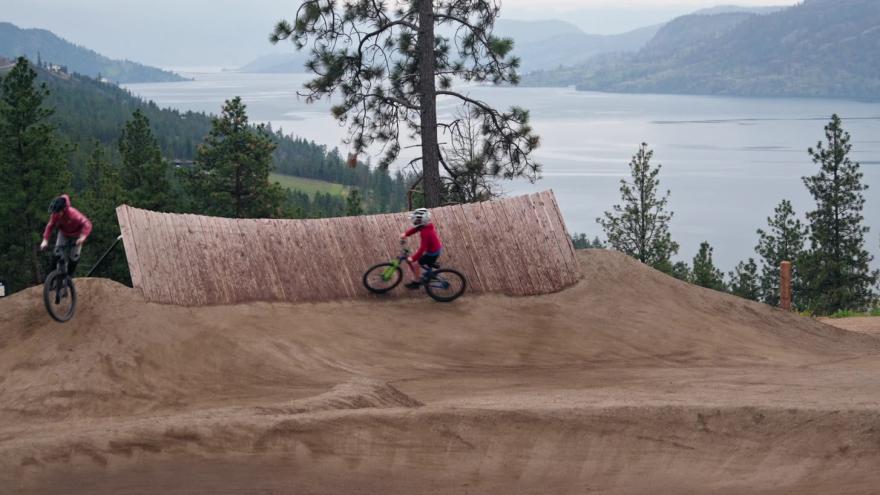 Kids riding their bikes over berms