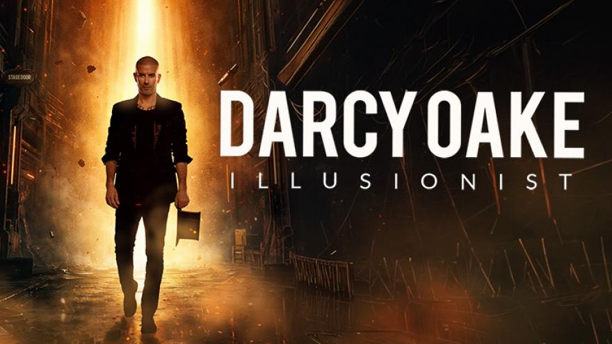 Darcy Oake walking through an alleyway with a bright yellow and orang beam of light backlighting him