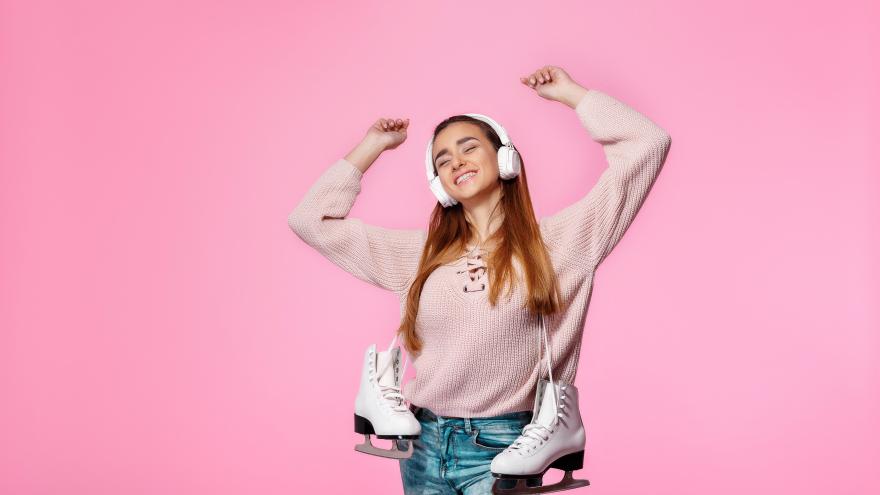 Girl listening to music with ice skates 