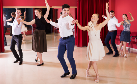 Couples practicing dance moves together