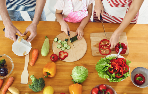 three sets of hands chopping on cutting boards