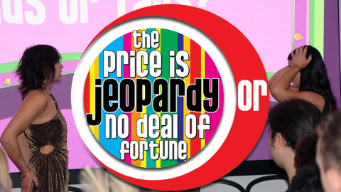 still frame of modern day price is right show eith showcase hosts and contestans in foreground. Title of show in red circle