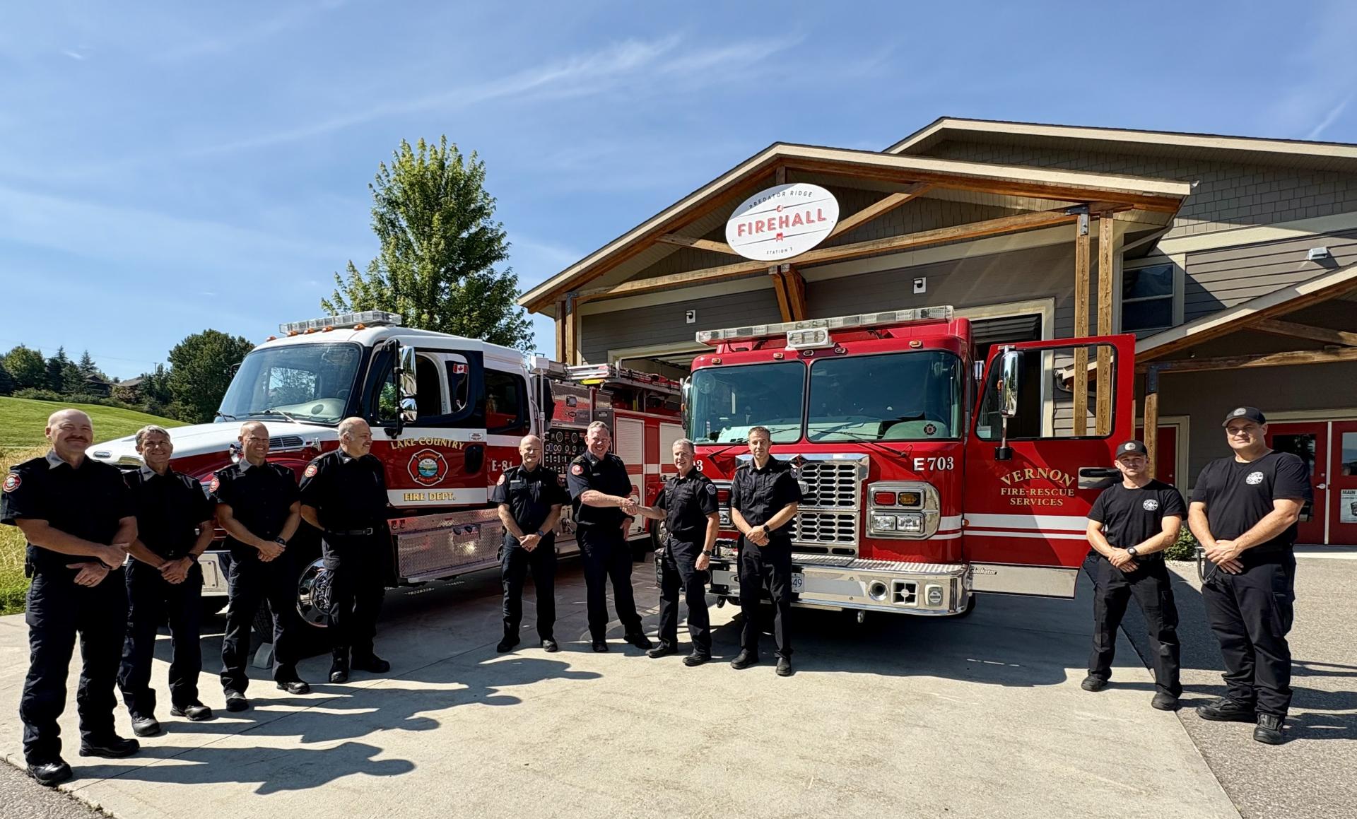 Lake Country and Vernon fire chiefs shaking hands to symbolize new mutual aid agreement
