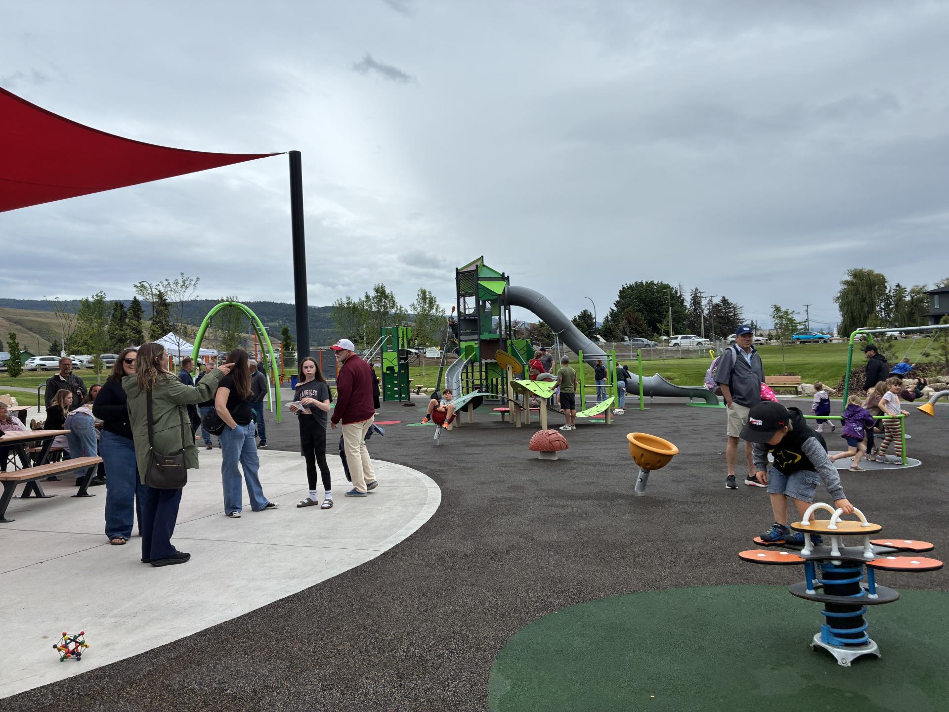 children and adults enjoy the new park
