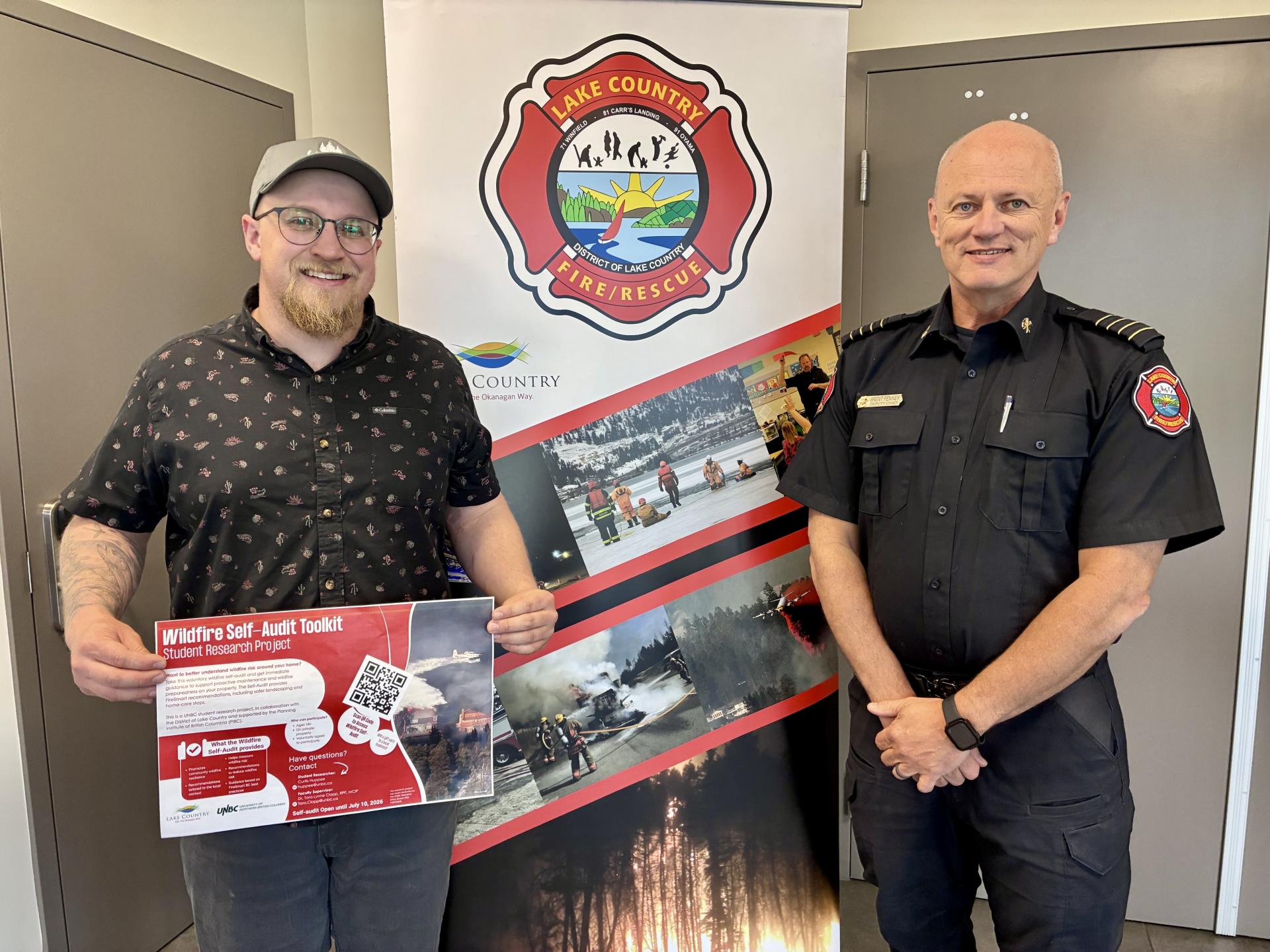 student and deputy fire chief pose with project poster