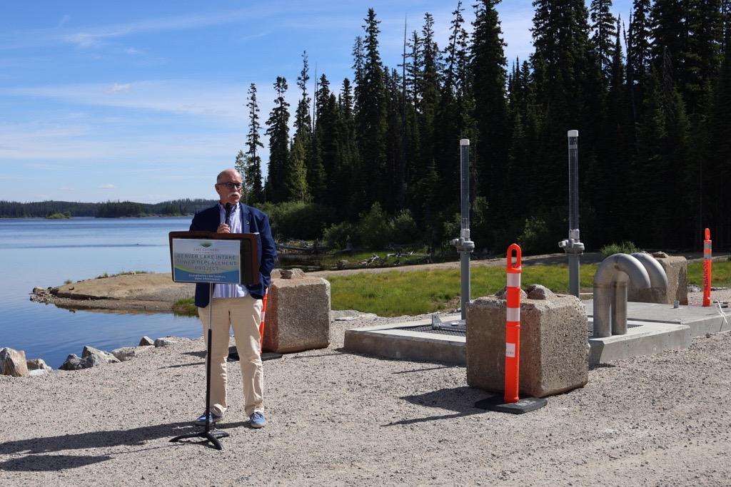 Mayor Ireland speaking at a podium celebrating the completed of the Beaver Lake Dam water infrastructure project.